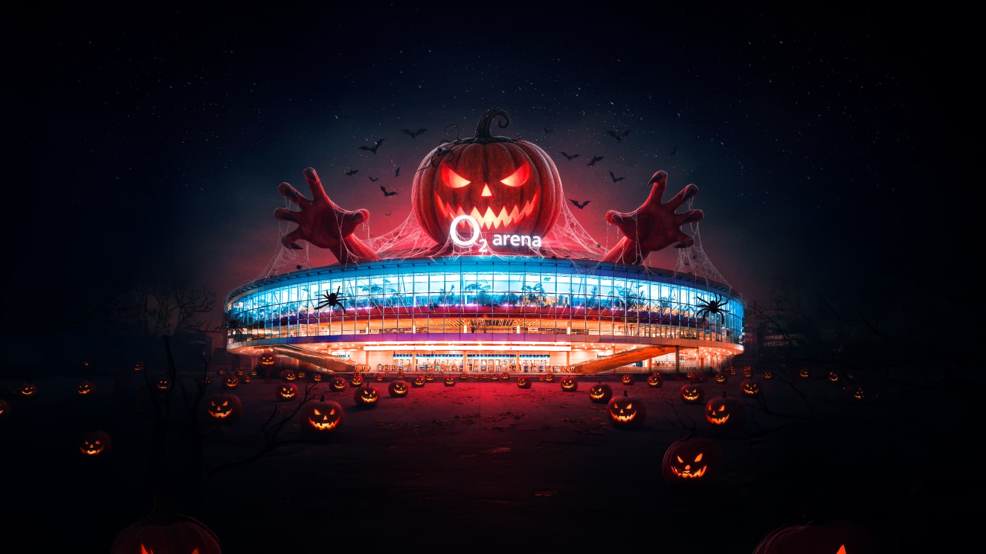 O2 arena obklopená svítícími dýněmi a obří halloweenskou postavou